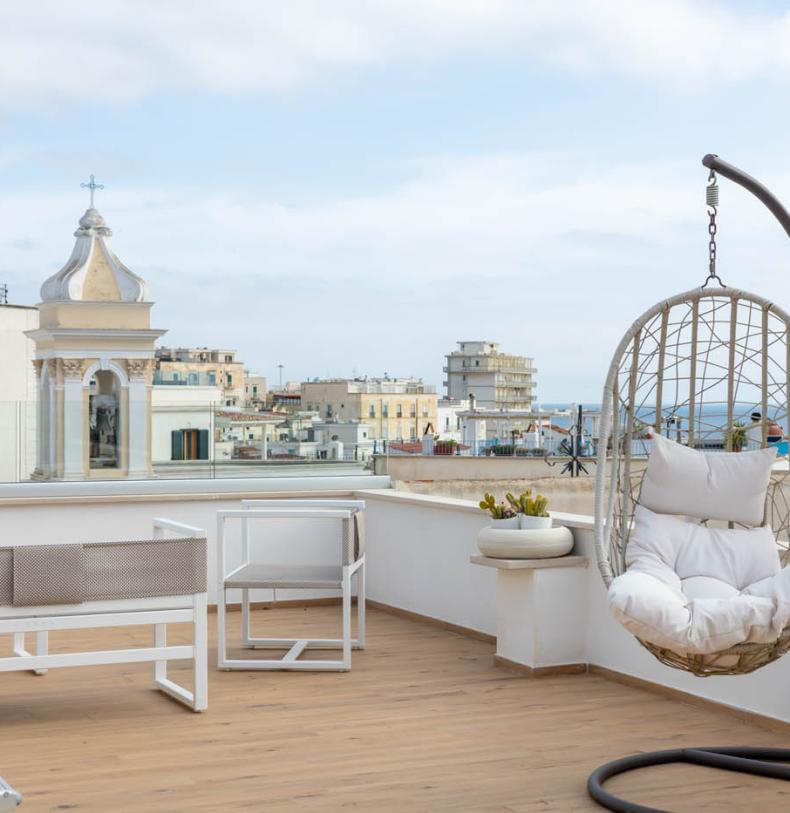 Terrace with hanging chair and sea view.