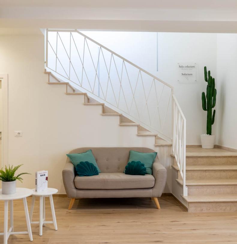 Modern room with sofa, plant, and historical map.